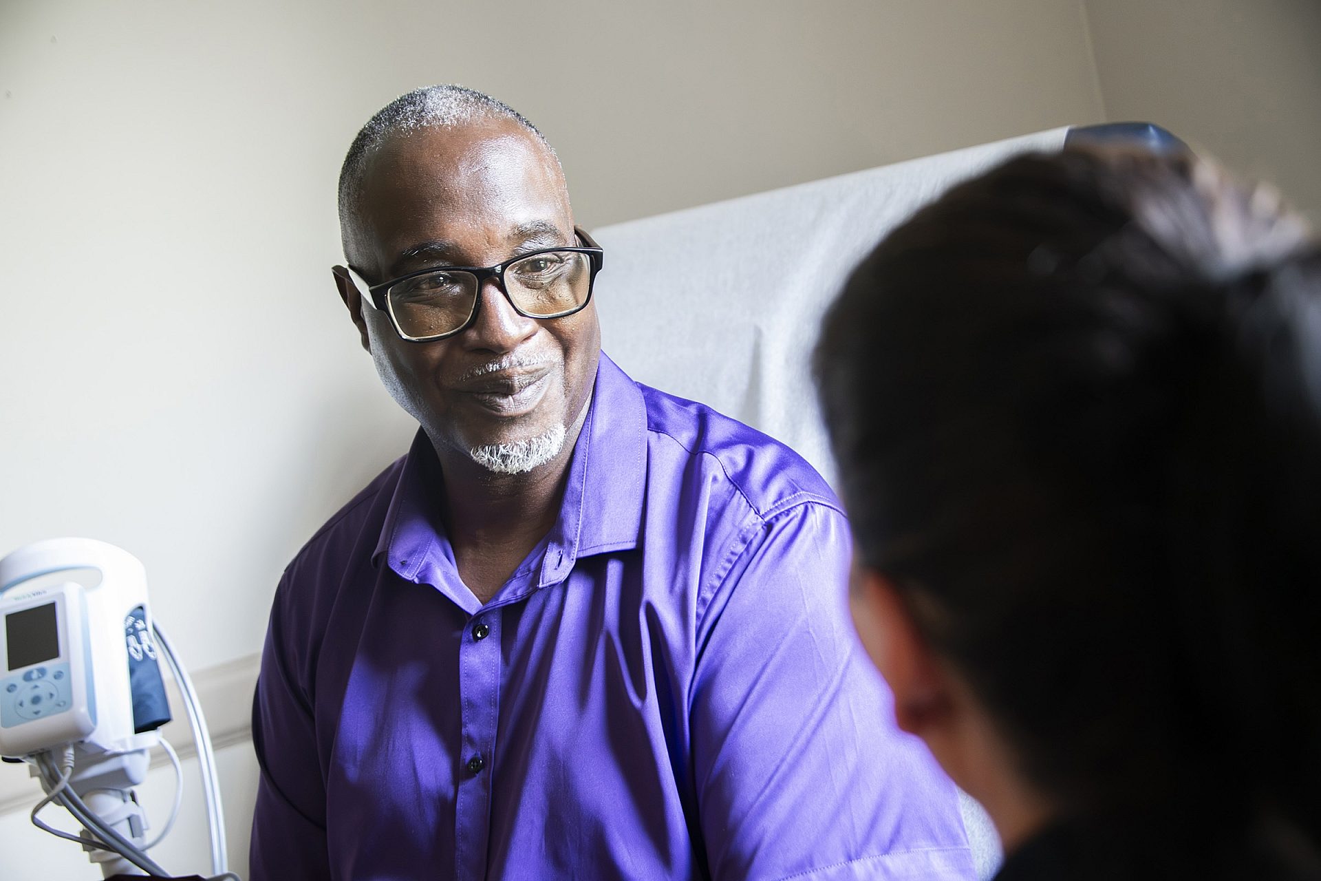 Smiling patient speaking with a care provider during a consultation at a Mississippi kidney clinic.