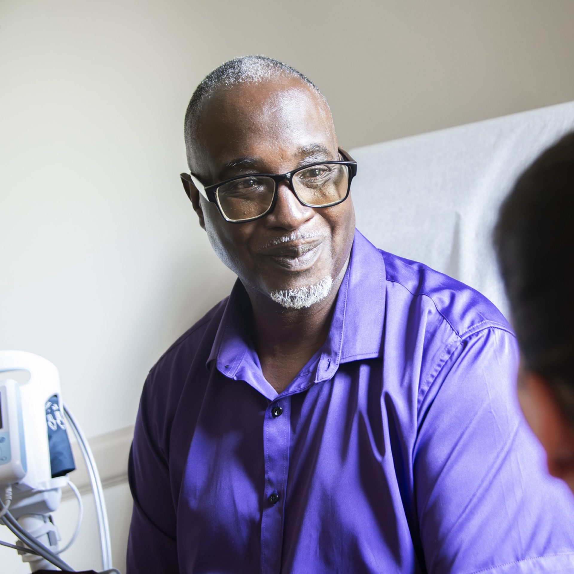 Smiling patient speaking with a care provider during a consultation at a Mississippi kidney clinic.